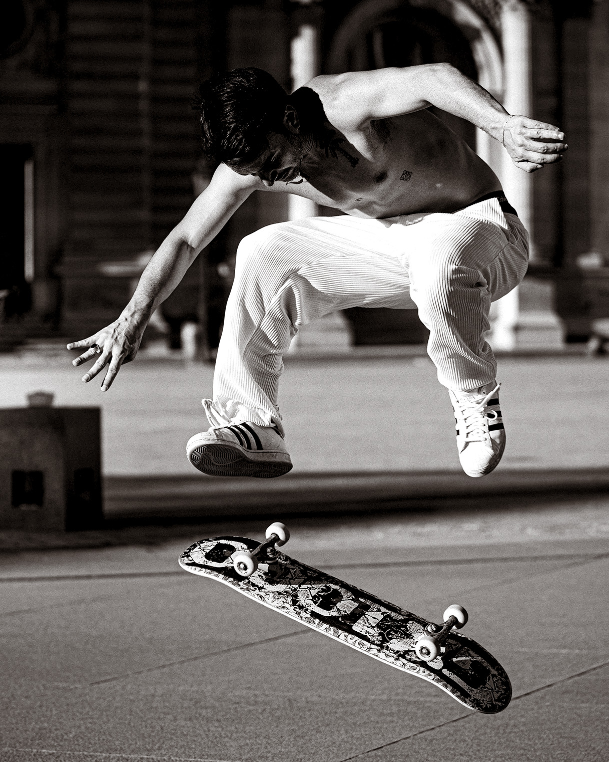 Skateboarder in der Luft über seinem Board, Schwarzweiß